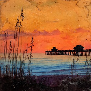 May include: A vibrant sunset painting featuring a silhouette of a long wooden pier extending into the ocean. Tall sea oats frame the foreground against a bright orange and yellow sky, with deep blue water reflecting the warm light of the horizon.