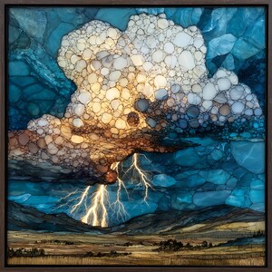 May include: A framed artwork depicting a stormy landscape. The image features a large cloud formation with a mix of white, tan, and brown tones, and bright yellow lightning bolts. The background shows dark blue mountains and a tan field.