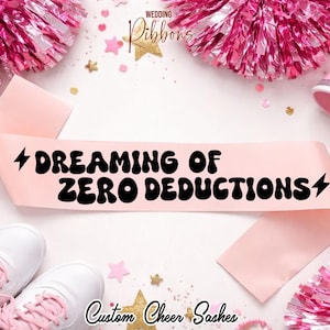 May include: A light pink sash with the text "DREAMING OF ZERO DEDUCTIONS" in black, with lightning bolt graphics. The sash is surrounded by pink pom-poms, white sneakers, and gold star confetti. The words "Wedding Ribbons" and "Custom Cheer Sashes" are also visible.