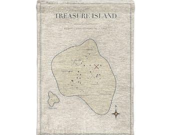 May include: A rectangular beige fabric wall hanging featuring a map of Treasure Island by Robert Louis Stevenson. The design includes black line drawings of the island, a compass rose, and an X marking a spot, all on a textured background.