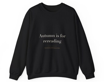 May include: A black long-sleeve crewneck sweatshirt featuring the white text "Autumn is for rereading" centred on the chest, with a smaller line of text below that reads "No new books until the leaves are down."