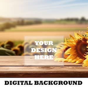 Könnte beinhalten: Ein Holztisch mit einem Strauß gelber Sonnenblumen im Vordergrund. Der Hintergrund ist ein verschwommenes Bild eines Feldes mit blauem Himmel. Der Text "YOUR DESIGN HERE" befindet sich auf einem weißen Rechteck in der Mitte des Tisches.