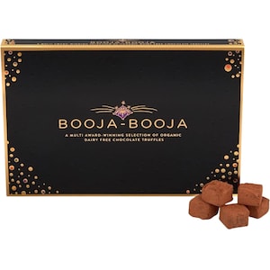 May include: A black box of Booja-Booja organic dairy-free chocolate truffles. The box has gold accents and the brand name in gold lettering. Several cocoa-dusted truffles are in front of the box.