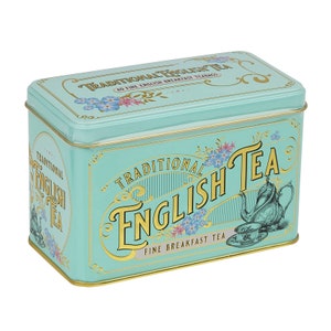May include: A teal blue tin with gold trim and lettering. The tin has a traditional English tea design with a teapot and teacups. The text on the tin reads "Traditional English Tea" and "Fine Breakfast Tea".