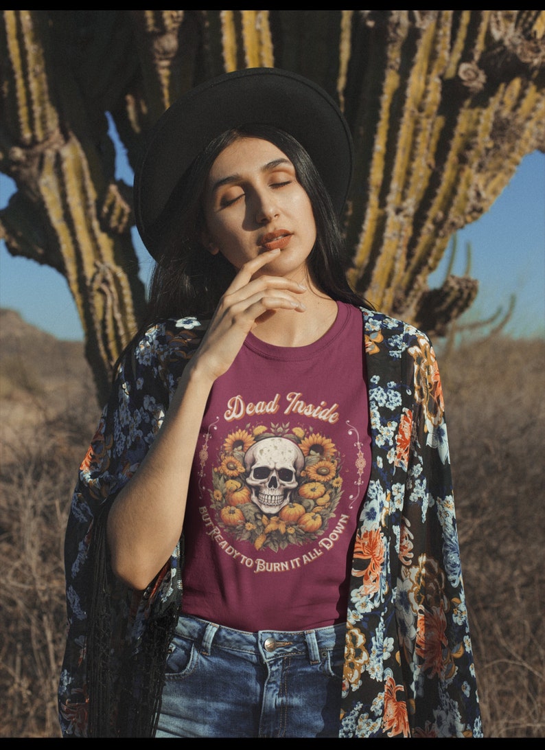 May include: A maroon t-shirt with a skull and sunflowers graphic. The text on the shirt reads "Dead Inside But Ready To Burn It All Down".