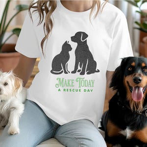 May include: White t-shirt with a black silhouette of a dog and cat, and the text "Make Today A Rescue Day" in green.