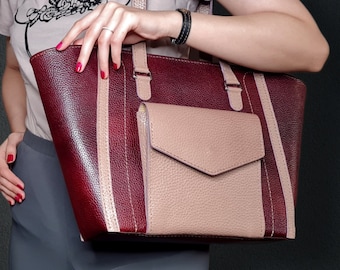 May include: A burgundy leather tote bag with a beige leather pocket and white stripes. The bag has two top handles. The text "PDF DOWNLOAD DIY TUTORIAL VIDEO" is visible in the image.