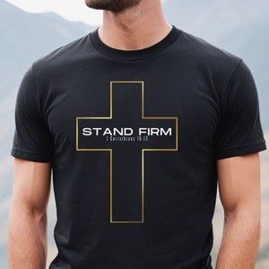 May include: Black t-shirt with a gold cross and the text "STAND FIRM 1 Corinthians 16:13"