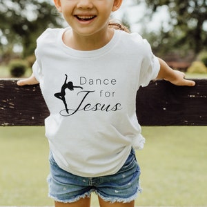 May include: A white t-shirt with a black silhouette of a dancer and the text "Dance for Jesus".