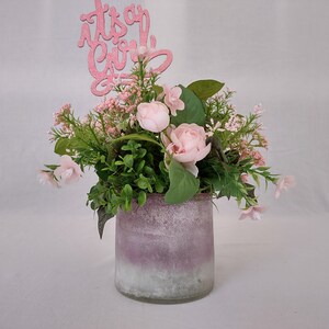 Girl Baby Shower Centerpiece with pink roses, wildflowers, and greenery in a pink to white ombre glass vase. Glittery &quot;Its A Girl&quot; pick.