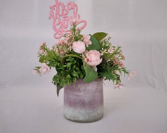 Girl Baby Shower Centerpiece with pink roses, wildflowers, and greenery in a pink to white ombre glass vase. Glittery "Its A Girl" pick.