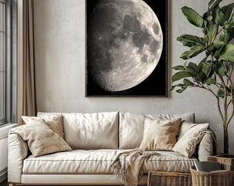 May include: A black and white photograph of a crescent moon against a dark background. The moon is the main focus of the image and is positioned in the center of the frame.
