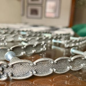 May include: A set of three ceramic mugs with a speckled, matte finish in cream, light grey, and dark grey. Each mug has a simple, minimalist design, suitable for coffee or tea.