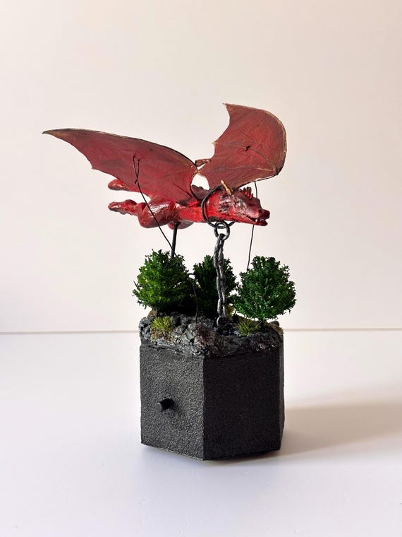 A handcrafted mechanical dragon automaton whose wings actually move — kinetic sculpture meets fantasy art, the kind of desk piece that stops visitors mid-sentence.