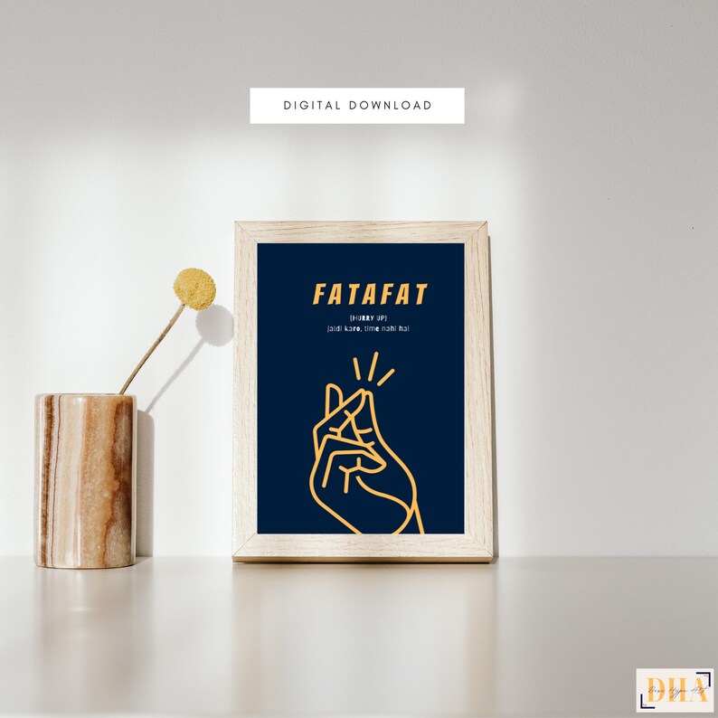 May include: A framed print with a dark blue background and a yellow outline of a hand making a snapping gesture. The text "FATAFAT (hurry up!) Just like, come now!" is written in yellow.