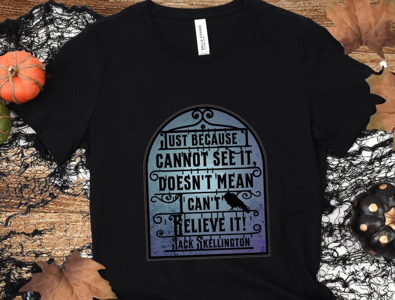 Pode incluir: Camiseta preta com um gr&aacute;fico de um port&atilde;o com o texto "JUST BECAUSE CANNOT SEE IT, DOESN'T MEAN CAN'T BELIEVE IT!" e "JACK SKELLINGTON" abaixo.