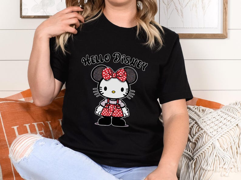 May include: Black t-shirt with a white Hello Disney graphic and a cartoon image of a red and white polka dot Hello Kitty character with a red bow.