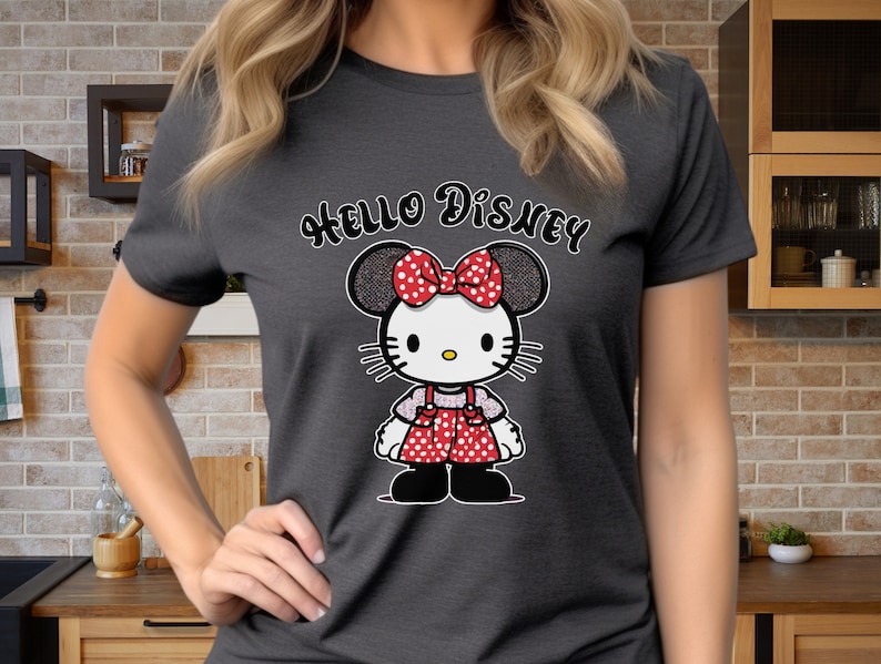May include: A dark gray t-shirt with the text "Hello Disney" printed in white. A cartoon image of a red and white polka dot Minnie Mouse with a bow is centered on the shirt.