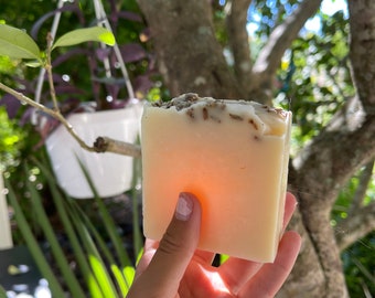 May include: A rectangular bar of handmade soap with a light beige color and a light brown top layer. The soap has a subtle lavender scent and is made with natural ingredients.