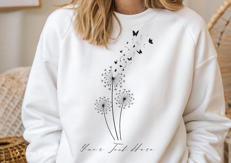 May include: White sweatshirt with a black dandelion design and butterflies flying away. The text "Your Text Here" is printed below the design.