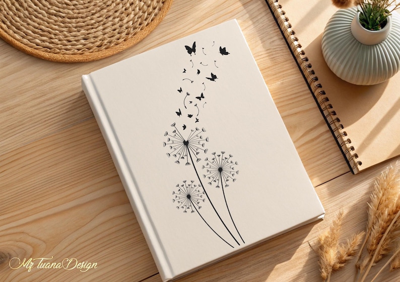 May include: A white journal with a black dandelion design and butterflies flying away. The journal has a simple, elegant design.
