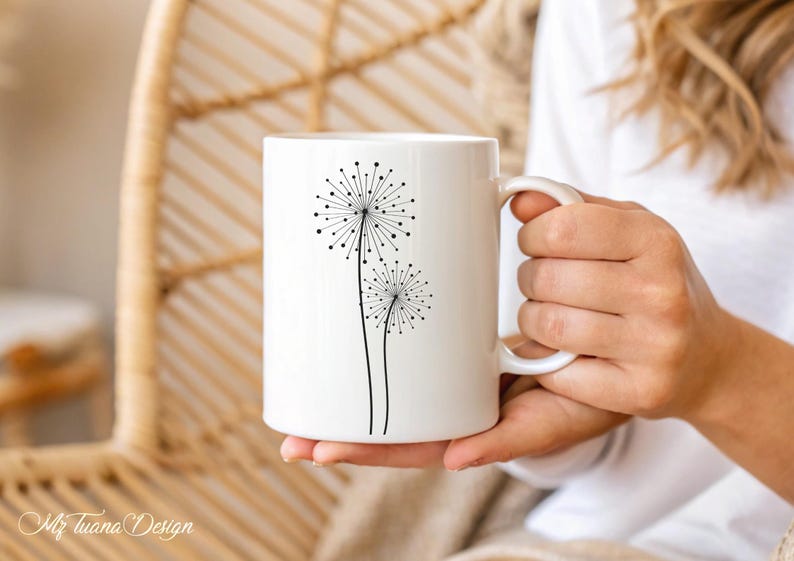 May include: White ceramic mug with a black silhouette of two dandelions on the front.