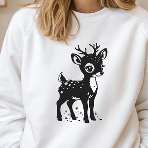 May include: White sweatshirt with a black and white graphic of a cute deer with spots. The deer is standing on a white background with a few small black dots around it.