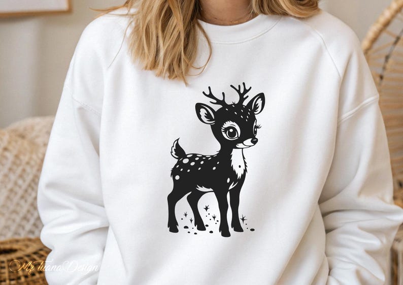 May include: White sweatshirt with a black and white graphic of a cute deer with spots. The deer is standing on a white background with a few small black dots around it.