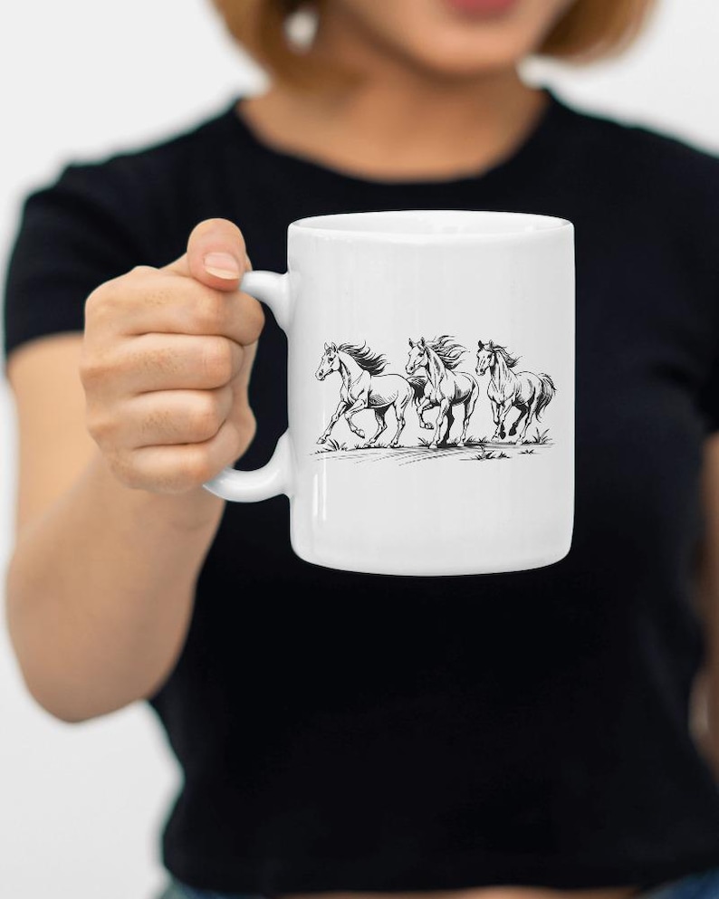 May include: White ceramic mug with a black line drawing of four horses running. The horses are in a line, with the first horse in the lead and the last horse in the back. The horses are all facing the same direction.