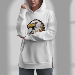 May include: White hooded sweatshirt with a graphic of a bald eagle's head on the front.