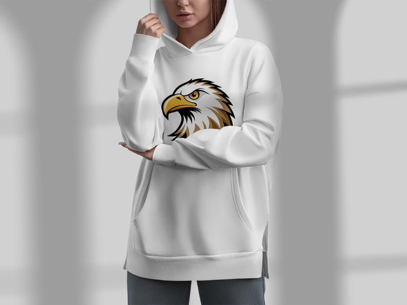 May include: White hooded sweatshirt with a graphic of a bald eagle's head on the front.