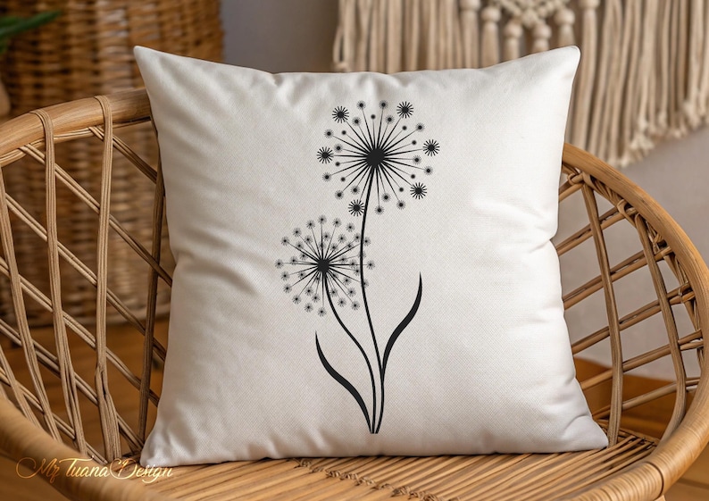 May include: A white pillow with a black silhouette of two dandelions with their seeds blowing in the wind.