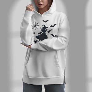 May include: White hoodie with a black silhouette of a witch flying with bats and a spider web.