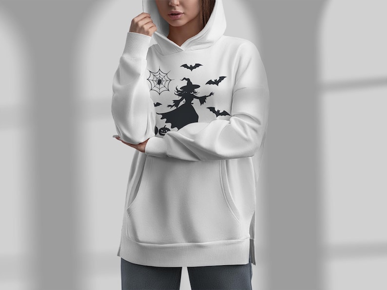 May include: White hoodie with a black silhouette of a witch flying with bats and a spider web.