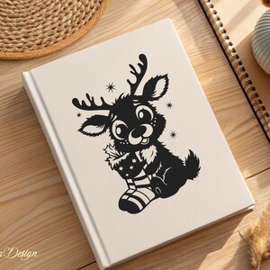 May include: A black and white illustration of a reindeer holding a Christmas stocking. The reindeer has large eyes and a smiling face.