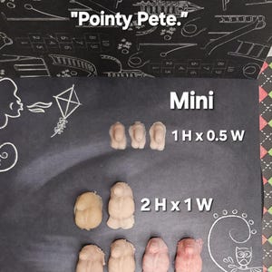 May include: Miniature sculptures in shades of beige and pink are displayed on a dark surface. The image includes the text "Mini" and size measurements of 2.5 cm H x 1.3 cm W and 5 cm H x 2.5 cm W. The phrase "Pointy Pete" is also present.