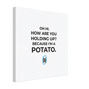 May include: White canvas art print featuring the text "OH HI. HOW ARE YOU HOLDING UP? BECAUSE I'M A POTATO." A blue and white portal-themed graphic is at the bottom. The art is displayed at an angle.