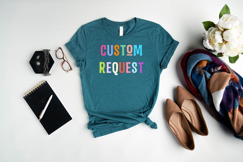 May include: Teal blue t-shirt with the text "CUSTOM REQUEST" in rainbow colors.