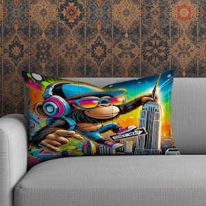 May include: A rectangular throw pillow featuring a vibrant cartoon monkey wearing sunglasses and headphones, holding a "One Way" sign and touching the Empire State Building. The pillow has a colorful, graffiti-style design with a cityscape background.