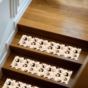 May include: Stair treads with a cream background and a repeating pattern of black, brown, and tan circles and ovals. The treads are rectangular and placed on wooden stairs.