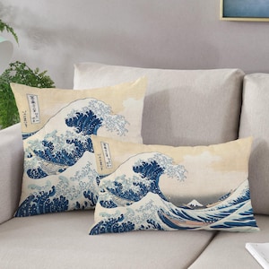 May include: Two decorative throw pillows with a Japanese wave design. The pillows are beige with a blue wave pattern and Japanese text.