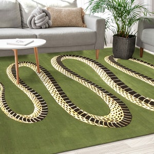May include: A green rug featuring a black and white snake design. The snake is winding its way across the rug. The rug has a green background and the snake is a black and white pattern.