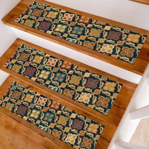 May include: Stair treads with a navy blue background and a repeating floral pattern in shades of gold, red, and blue. The treads are rectangular and placed on wooden stairs.