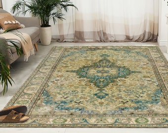 Könnte beinhalten: Ein Teppich im Vintage-Stil mit cremefarbenem Hintergrund und aufwendigen Blumenmustern in Blautönen, Grün- und Brauntönen. Der Teppich hat einen Rand mit Paisley-Muster.