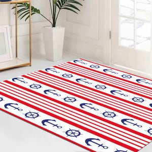 May include: A red and white striped rug with blue anchors and steering wheels. The rug has a nautical theme.