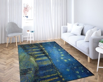 May include: A blue and yellow area rug with a painting of a starry night sky. The rug features a depiction of a landscape with trees and a winding path. The painting is reminiscent of Vincent van Gogh's famous artwork.