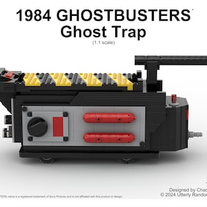 May include: A black LEGO Ghostbusters Ghost Trap model with yellow and red details. The model is 1:1 scale and has 1534 pieces. The text "1984 GHOSTBUSTERS Ghost Trap (1:1 scale)" is printed above the model. The text "1534pcs Designed by Chad Peterson © 2024 Utterly Random Designs" is printed below the model.
