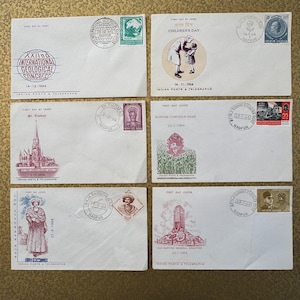 May include: Six vintage envelopes with stamps and postmarks from India. The envelopes feature various themes, including the XXIInd International Geological Congress, Children's Day, St. Thomas, a first day cover for the Ashoka Chauk, a first day cover for Raja Rammohun Roy, and a first day cover for the I.N.A. Martyrs Memorial. The envelopes are in good condition and have a variety of colors and designs.