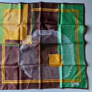 May include: A brown, green, and yellow patterned silk scarf with a geometric design. The scarf has a white border and the word "Paoli" in the bottom right corner.