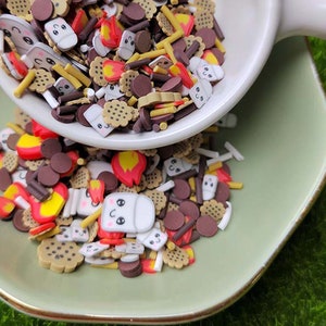 May include: A variety of colorful sprinkles in the shape of marshmallows, chocolate chips, graham crackers, and fire. The sprinkles are perfect for decorating cakes, cupcakes, and other desserts.